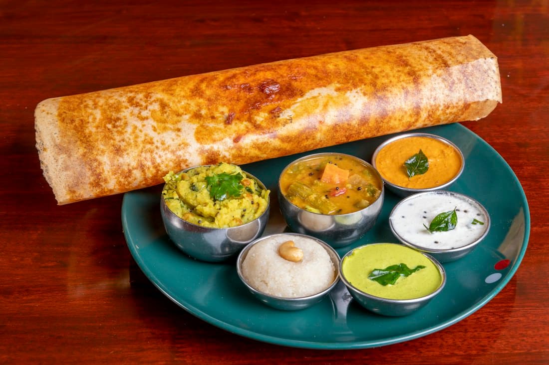 A dosa served with coconut chutney and sambar
