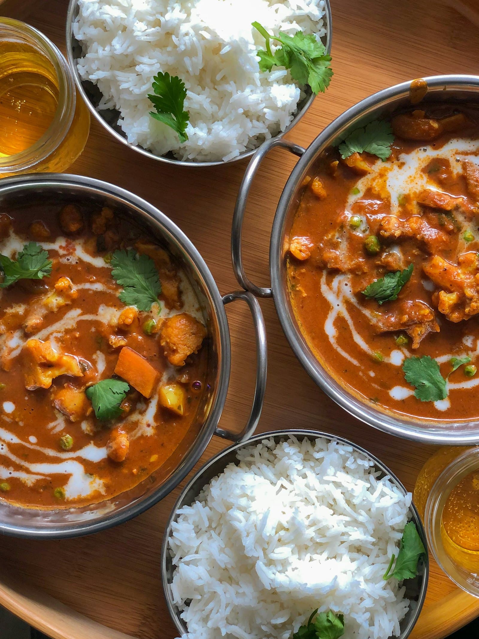 A table of curries, rice and breads shared between friends